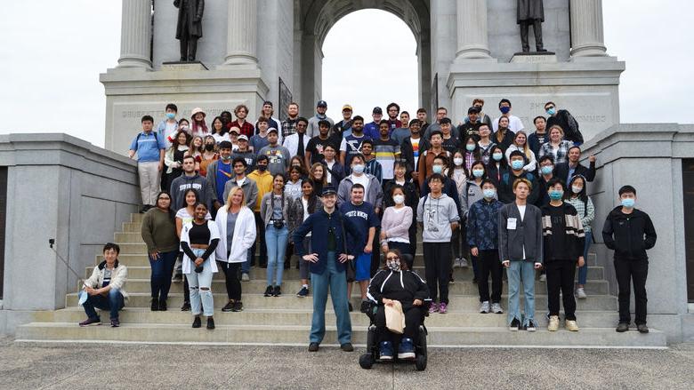 A large group of students standing on steps in front of the Pennsylvania Memorial